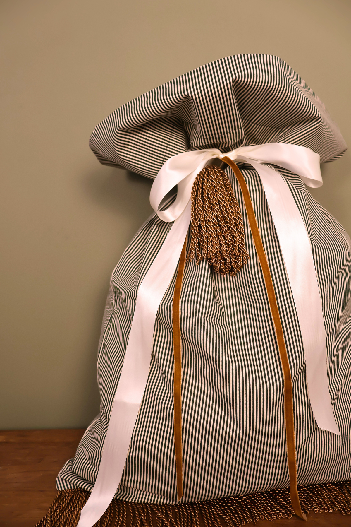 Green striped Santa sack with a cream satin ribbon, caramel velvet ribbon and gold tassel
