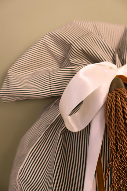 Cream satin bow on the gathered top of the green striped Santa sack