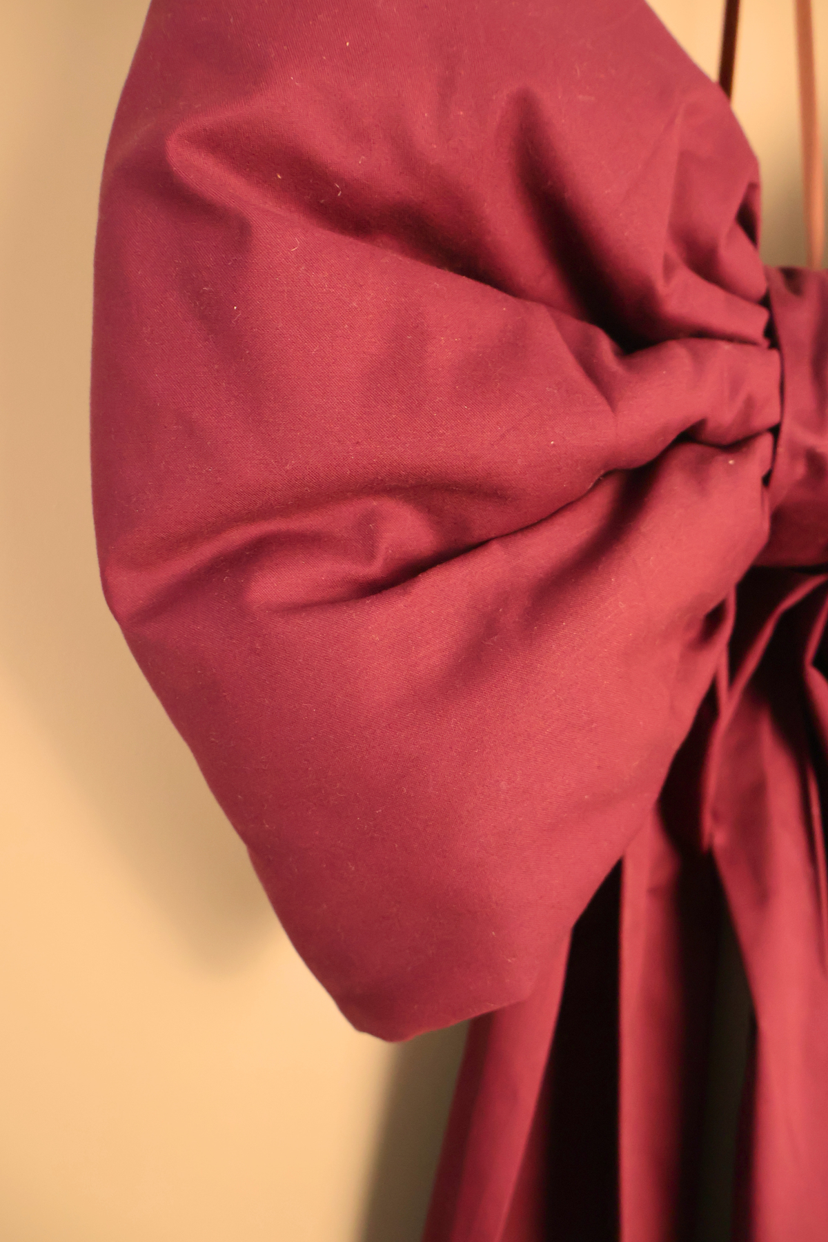 Close up of the burgundy oversized bow showing the soft padded loop and knot
