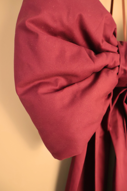 Close up of the burgundy oversized bow showing the soft padded loop and knot