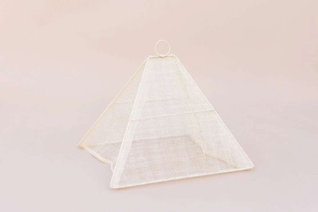 Small collapsible woven food tent cover in cream, folded flat for storage