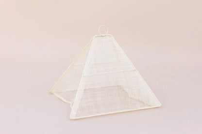 Small collapsible woven food tent cover in cream, folded flat for storage