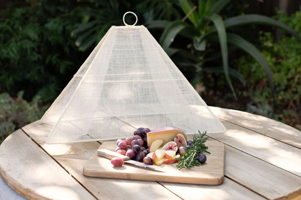 Small collapsible woven food tent cover in cream, styled setting